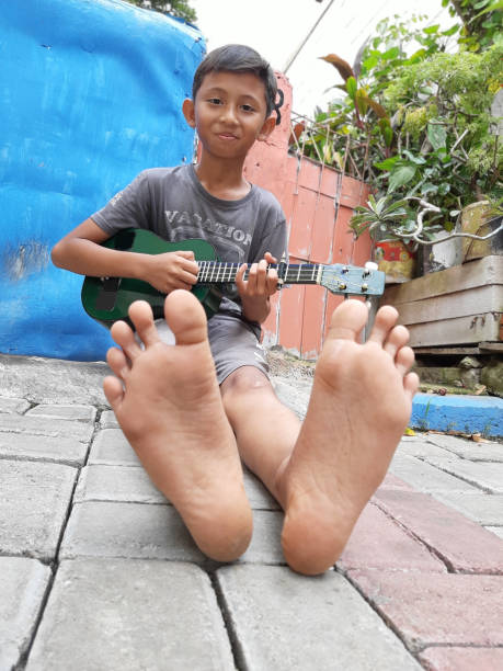 istock A Young Indonesian Boy Plays His Mandolin. 1198979772