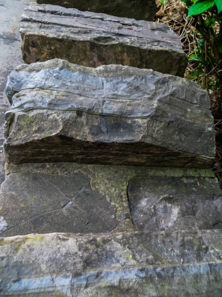 istock Decorative wall made of gray, rough stones. 1198980114