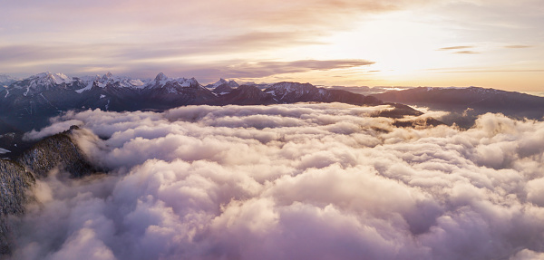 sunset above clouds in Alps mountains, beautiful cloudscape panorama view