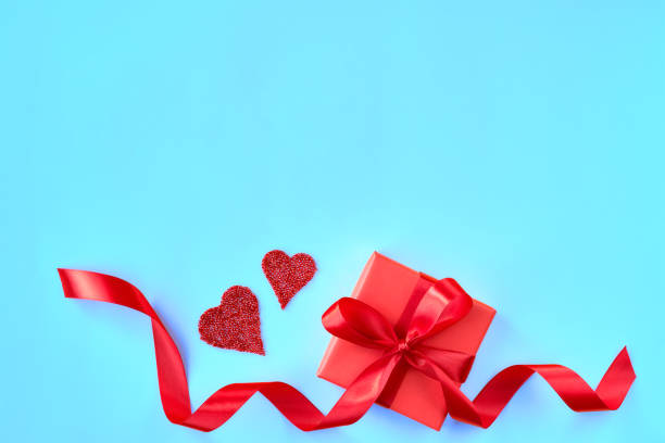 istock Valentine day card with gift box and heart on blue background. 1198981529