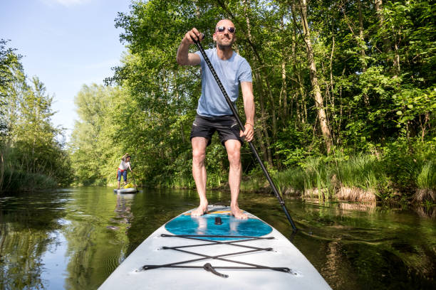 istock Couple on stand up paddle board on the lake, SUP 1198982852