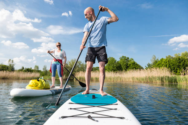 Couple on stand up paddle board on the lake, SUP