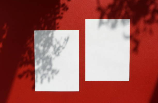 istock Empty white blank mockup with soft floral shadows on dark red background. modern sunlight stationery mockup scene. Flat lay, top view. copy space 1198983837