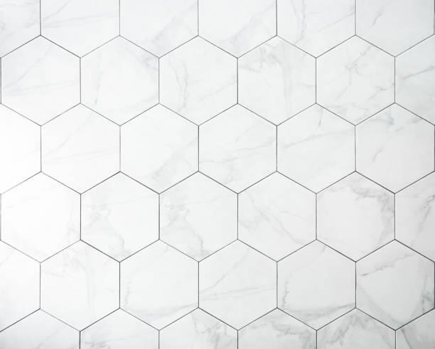 Tiles. A white marble wall with hexagon tiles for texture and background. stock photo