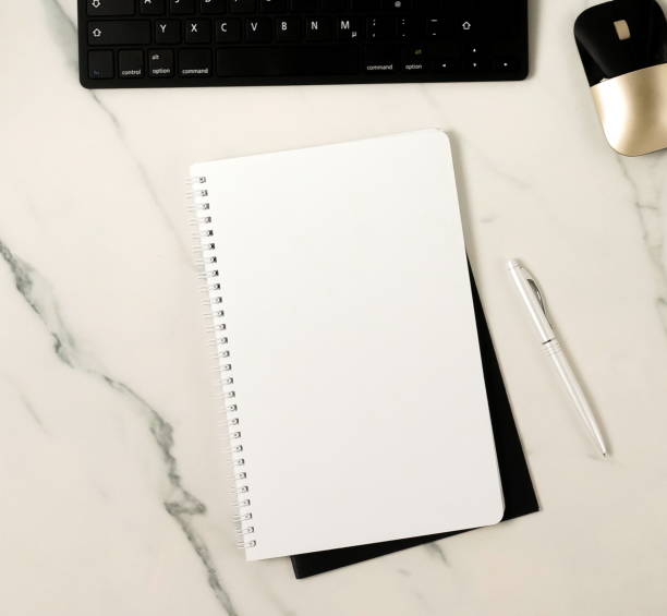 istock Notebook mock up and pen top view on marble background. Copy space 1198985077