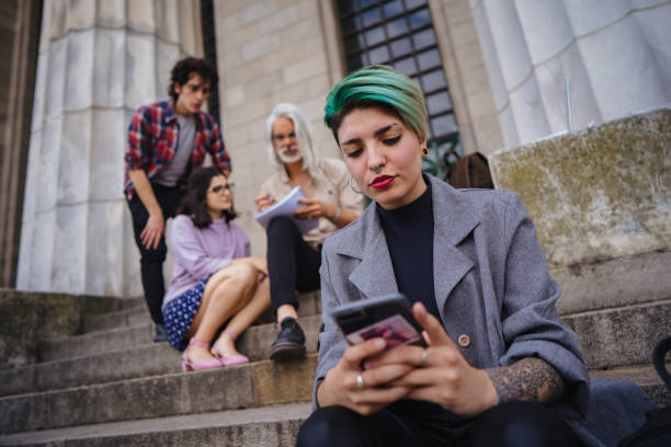 istock Female student chatting on smart phone 1198985236
