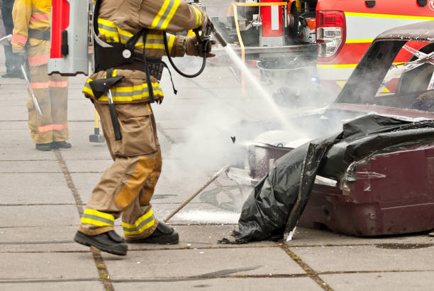 istock The fireman extinguishes the burned car. Training firefighters. Demonstration rescue work. 1198989942