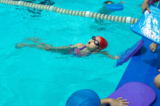 istock kid learn how to swim in swimming class 1198990643