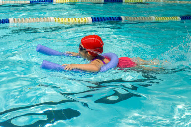 istock kid learn how to swim in swimming class 1198990656