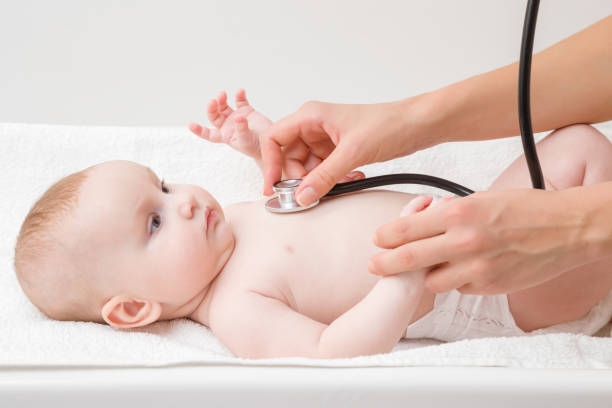 Woman hand holding stethoscope and listening baby heartbeat. Close up. Regular examining to pediatrician at hospital. Side view. Woman hand holding stethoscope and listening baby heartbeat. Close up. Regular examining to pediatrician at hospital. Side view. babyhood photos stock pictures, royalty-free photos & images