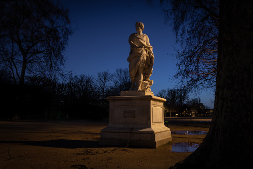 Early morning winter shot of a classical statue of a woman, Tuileries public garden, taken with long exposure, Paris, France