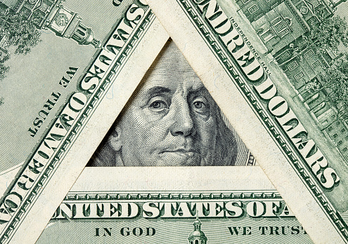 Triangle made of $100 bills with Benjamin Franklin inside