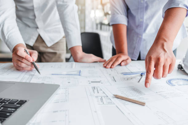 istock Team Engineer drawing graphic planning and meeting for architectural project on workplace 1198993453