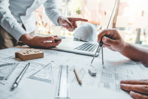 istock Team Engineer drawing graphic planning and meeting for architectural project on workplace 1198993510