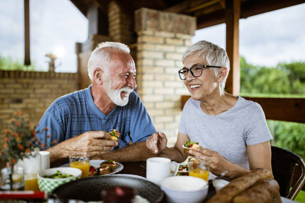 istock Happy mature couple enjoying while having breakfast on a balcony. 1198994159