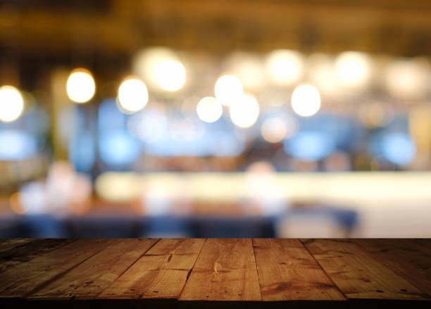 istock wooden table with  blurred cafe  restaurant 1198994276