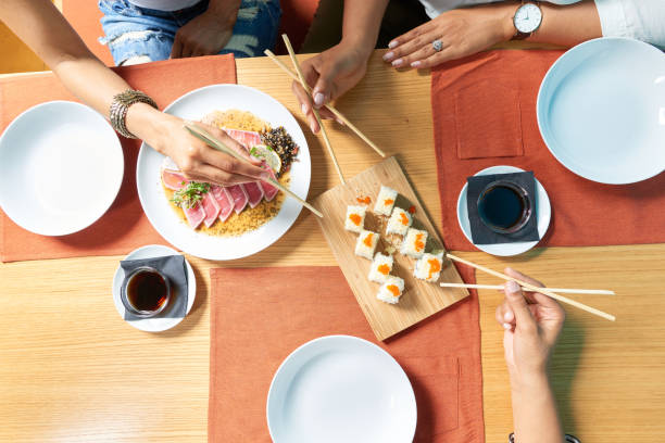 istock Three young women enjoy asian cuisine 1198994347