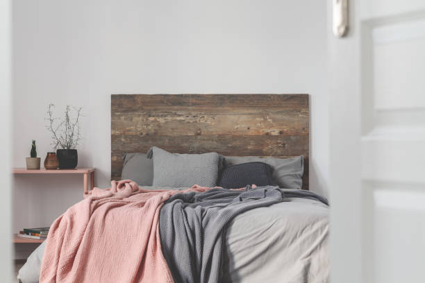 istock Copy space on empty white wall of rustic bedroom interior 1198999305