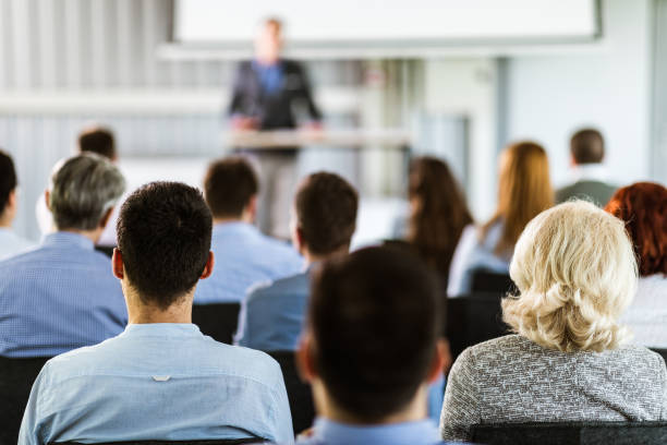 istock Back view of entrepreneurs having a training class in a board room. 1198999405