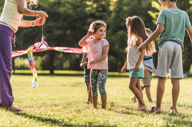 istock Kids playing with kite in nature 1198999466