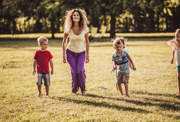 istock Happy kids jumping in nature 1199000467