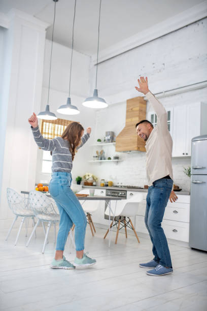 istock Father with daughter having fun dancing at home in kitchen. 1199002521