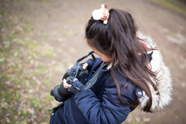 istock Girl taking a picture with an SLR camera 1199005544