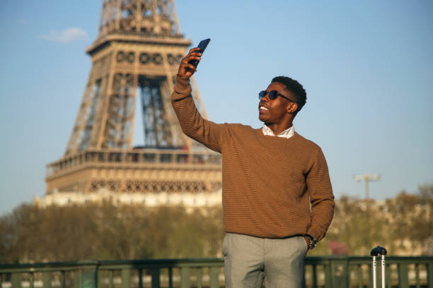 istock Smiling man taking a selfie in Paris 1199005556