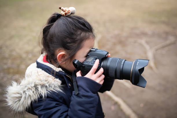 istock Girl taking a picture with an SLR camera 1199005604