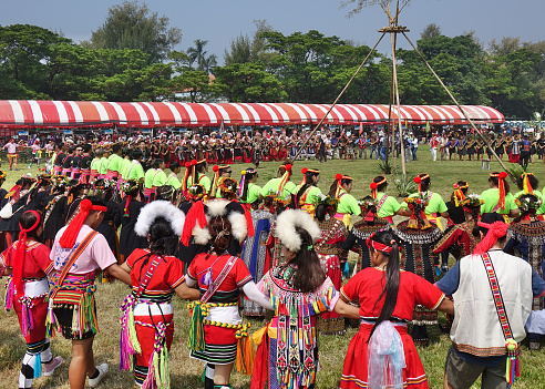 Kaohsiung, Taiwan -- September 28, 2019: Various indigenous tribes dance in a large circle during the traditional harvest festival.