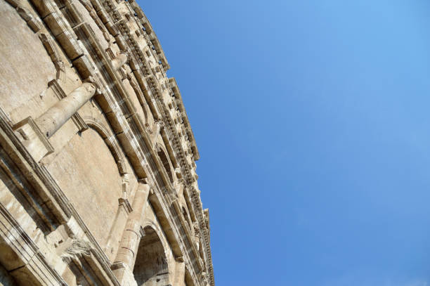 ROME / ITALY - AUGUST 2018: Exterior images of the ruins of The Colosseum filled with visiting tourists. Built in 70-80 AD the Colosseum remains one of the most popular tourist attractions in Italy.