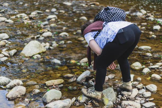 istock Senior woman playing near a river 1199006890