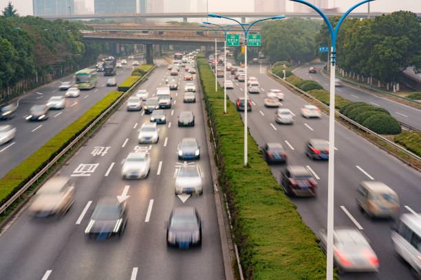 istock Blurred motion of busy traffic on a multi lane highway 1199007009