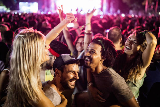 istock Carefree couples having fun while dancing on music festival. 1199007040