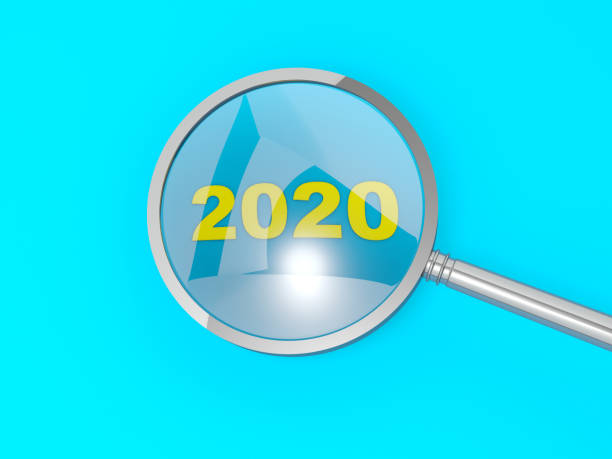 istock 2020 New Year sign under magnifier  on blue background 1199007125