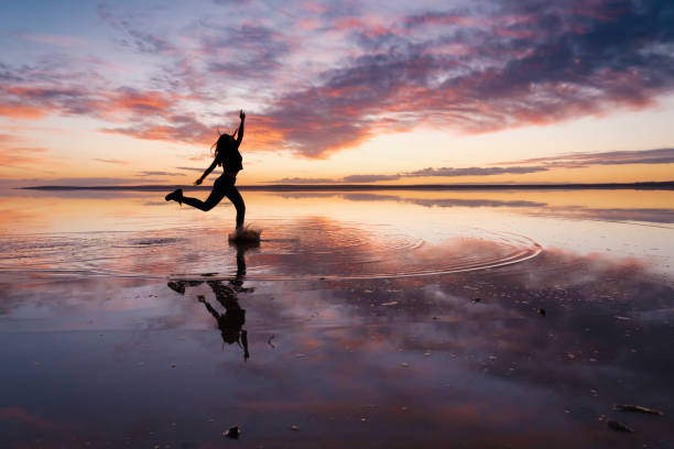 istock Dancing woman on salty lake. 1199008709