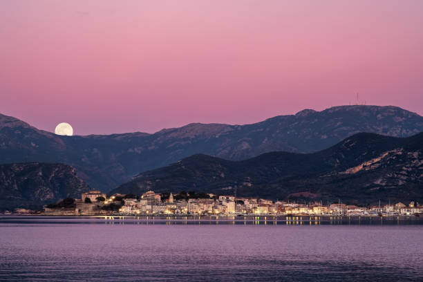 istock Full moon rising over St Florent in Corsica 1199008760