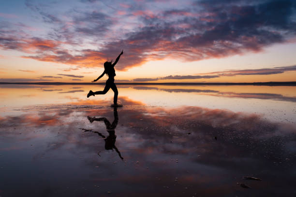 istock Dancing woman on salty lake. 1199008842