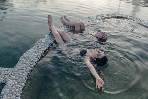 istock Friendship relaxing in thermal pool 1199009771