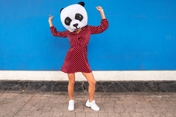 Woman in panda costume dancing at the city street