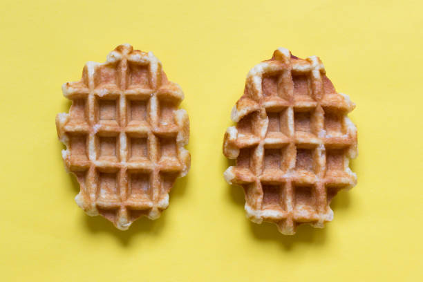 istock Two Belgian round waffles on yellow background 1199011180
