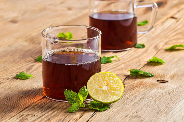 istock Cup of tea with ginger, lemon and mint on wooden table 1199011373