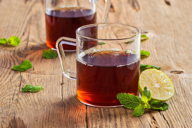 istock Cup of tea with ginger, lemon and mint on wooden table 1199011476