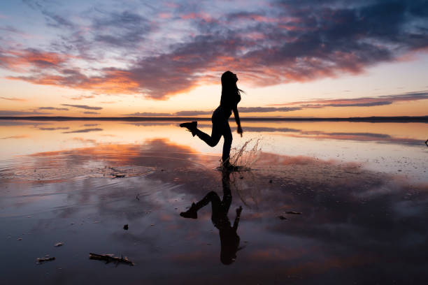 istock Dancing woman on salty lake. 1199011504