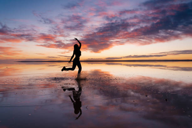 istock Dancing woman on salty lake. 1199011578