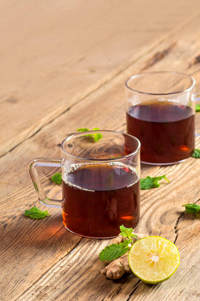 istock Cup of tea with ginger, lemon and mint on wooden table 1199011590
