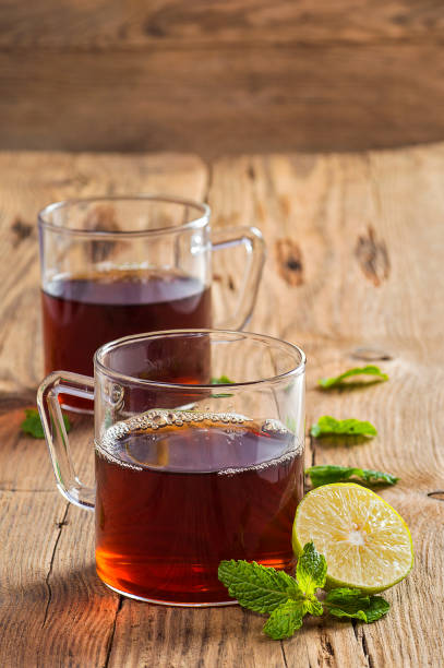 istock Cup of tea with ginger, lemon and mint on wooden table 1199011664