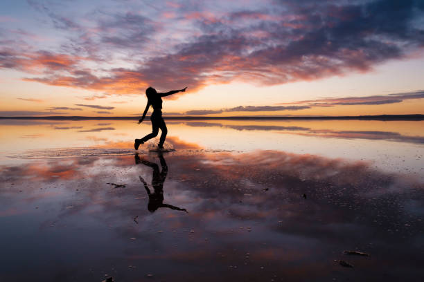 istock Dancing woman on salty lake. 1199012198