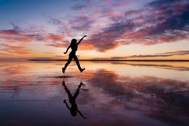 istock Dancing woman on salty lake. 1199012233