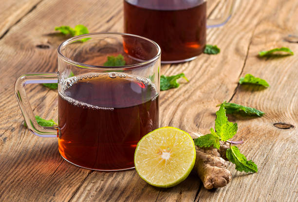 istock Cup of tea with ginger, lemon and mint on wooden table 1199012234